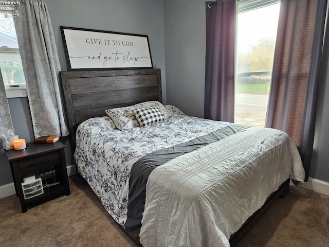 bedroom with baseboards and carpet flooring
