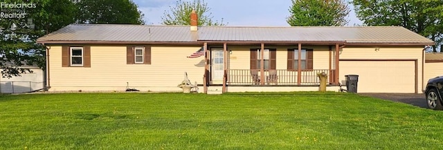 1733 County Road 302, Bellevue, OH 44811 - single story home with driveway, a front yard, an attached garage, metal roof, and a porch