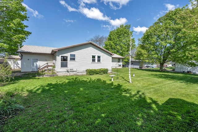 1733 County Road 302, Bellevue, OH 44811 - back of house with a lawn and metal roof