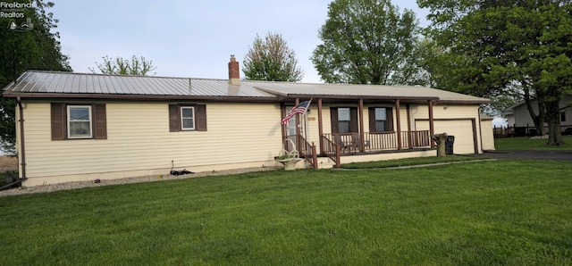 1733 County Road 302, Bellevue, OH 44811 - single story home with covered porch, a front yard, a garage, and asphalt driveway