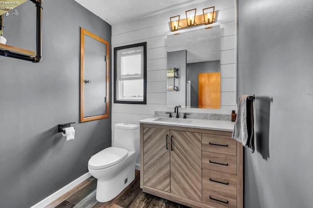 1733 County Road 302, Bellevue, OH 44811 - bathroom featuring wood finished floors, toilet, vanity, and baseboards