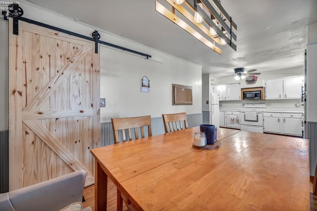 1733 County Road 302, Bellevue, OH 44811 - dining area with a barn door and a ceiling fan