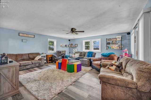 1733 County Road 302, Bellevue, OH 44811 - living room with healthy amount of natural light, ceiling fan, light wood-style floors, and a textured ceiling