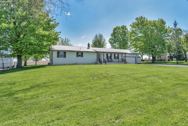 1733 County Road 302, Bellevue, OH 44811 - back of property featuring an attached garage, asphalt driveway, a chimney, and metal roof