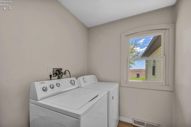 1733 County Road 302, Bellevue, OH 44811 - clothes washing area with washer and dryer, baseboards, and wood finished floors