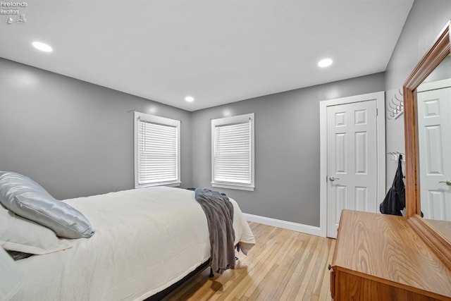 bedroom with light wood-type flooring, recessed lighting, and baseboards