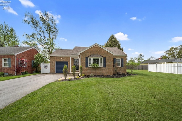 ranch-style home featuring a front yard, a garage, brick siding, fence, and aphalt driveway