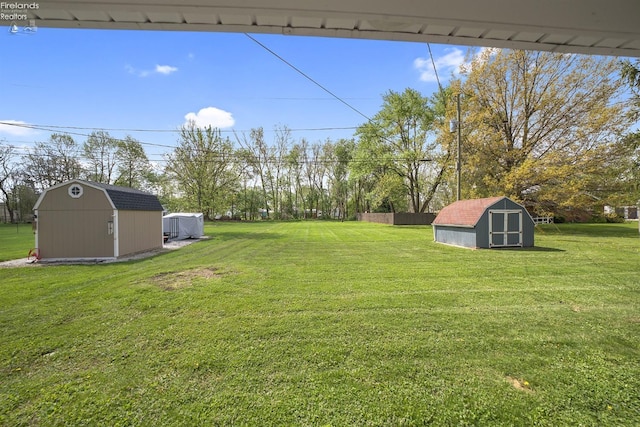 view of yard with a storage shed and an outbuilding