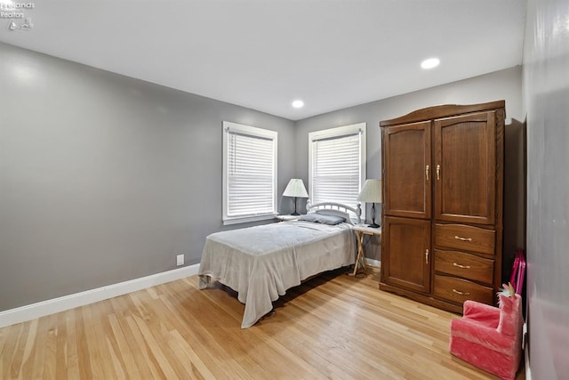 bedroom with light wood-style floors, baseboards, and recessed lighting