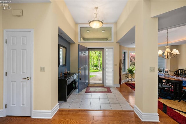 3535 E High Point Ln, Port Clinton, OH 43452 - entryway featuring light wood finished floors, a chandelier, and baseboards