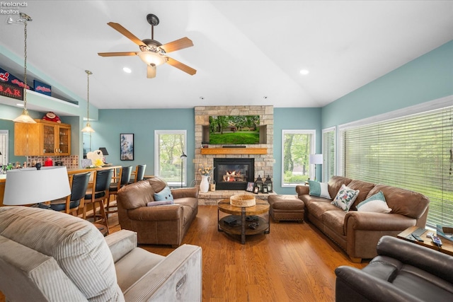 3535 E High Point Ln, Port Clinton, OH 43452 - living area with vaulted ceiling, wood finished floors, a ceiling fan, a fireplace, and recessed lighting