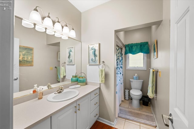 3535 E High Point Ln, Port Clinton, OH 43452 - full bath with vanity, toilet, tile patterned floors, baseboards, and a shower with shower curtain