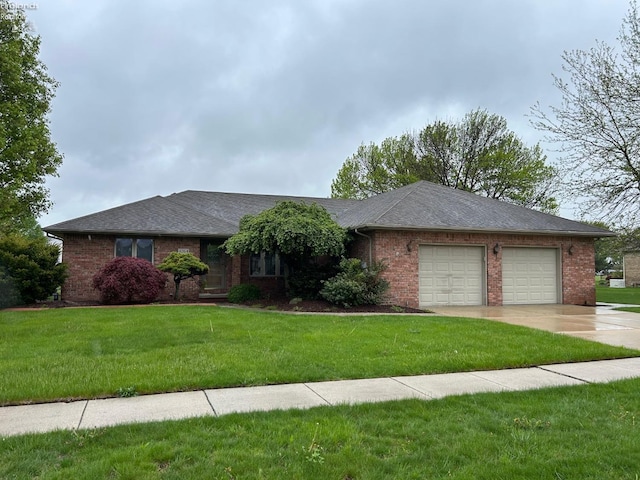 ranch-style home featuring a garage, concrete driveway, a front lawn, and brick siding