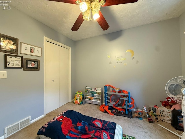 recreation room featuring a ceiling fan, carpet flooring, and visible vents