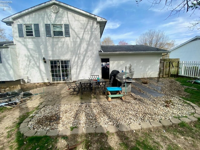 rear view of property with a patio and fence