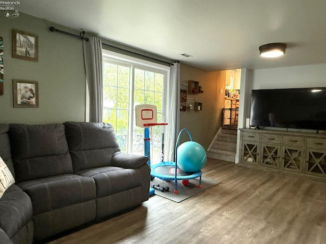 living room featuring visible vents and wood finished floors