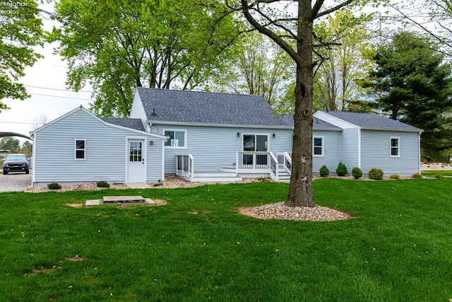 5033 Crestline Rd, Bucyrus, OH 44820 - back of house with roof with shingles, a deck, and a lawn