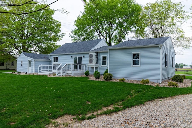 5033 Crestline Rd, Bucyrus, OH 44820 - back of house with roof with shingles, a wooden deck, and a lawn