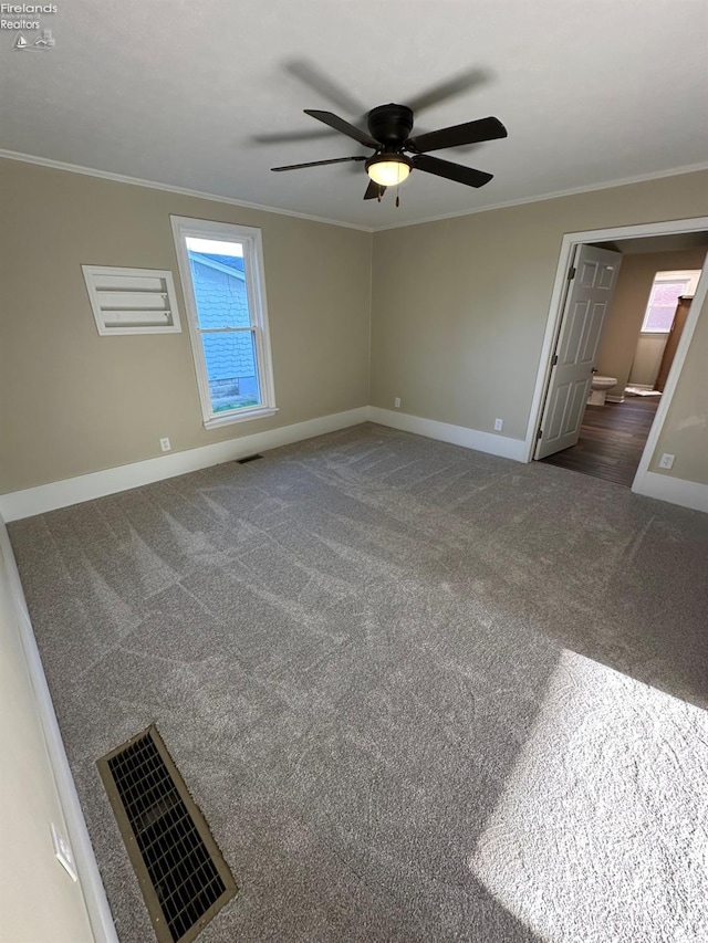 141 Main St, Castalia, OH 44824 - carpeted spare room with crown molding, visible vents, baseboards, and a ceiling fan