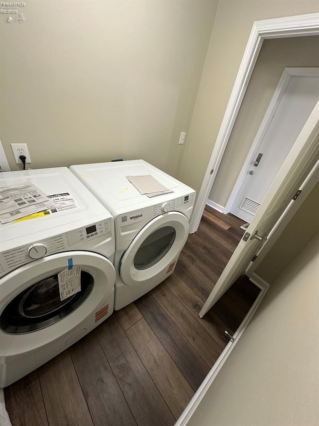 141 Main St, Castalia, OH 44824 - clothes washing area featuring washer and dryer, laundry area, visible vents, and dark wood-style floors