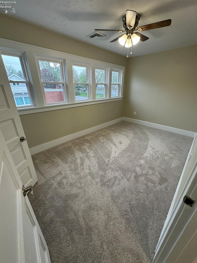 141 Main St, Castalia, OH 44824 - carpeted empty room with a ceiling fan, baseboards, and visible vents