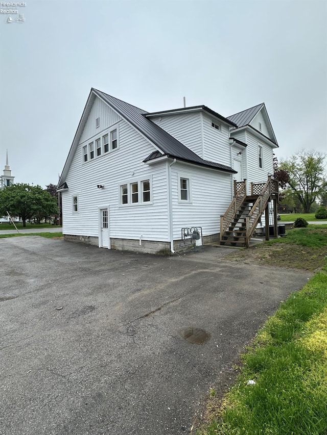 141 Main St, Castalia, OH 44824 - view of property exterior with metal roof, a standing seam roof, and aphalt driveway