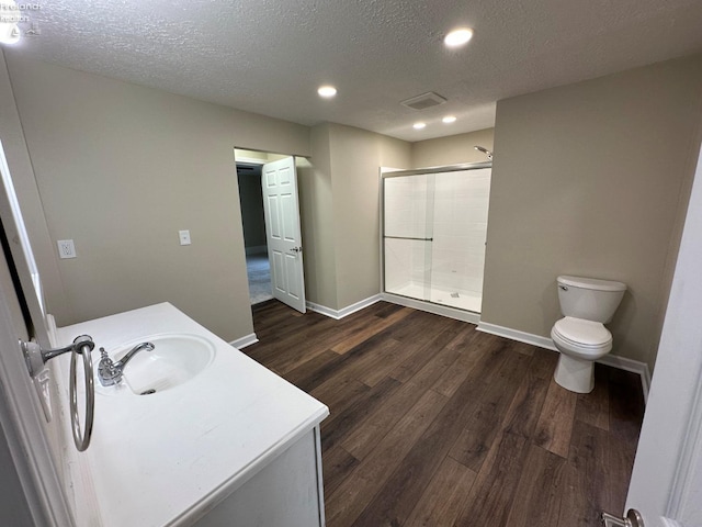 141 Main St, Castalia, OH 44824 - full bath featuring toilet, a textured ceiling, baseboards, and a shower stall
