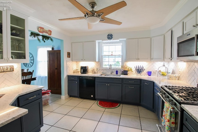 20 Chippewa Dr, Milan, OH 44846 - kitchen featuring a sink, stainless steel appliances, ceiling fan, white cabinetry, and backsplash