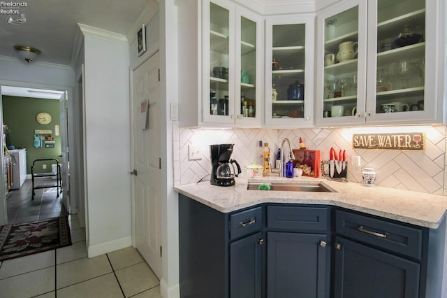 20 Chippewa Dr, Milan, OH 44846 - bar featuring a sink, ornamental molding, backsplash, light tile patterned floors, and baseboards