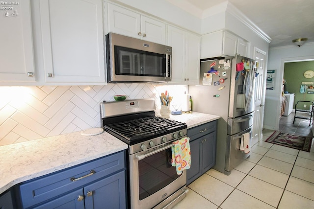 20 Chippewa Dr, Milan, OH 44846 - kitchen with stainless steel appliances, crown molding, white cabinetry, decorative backsplash, and light tile patterned flooring