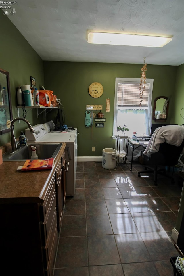 20 Chippewa Dr, Milan, OH 44846 - kitchen featuring baseboards, a sink, dark tile patterned floors, washer and clothes dryer, and dark countertops