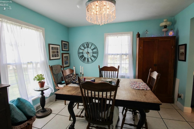20 Chippewa Dr, Milan, OH 44846 - dining space featuring light tile patterned floors, baseboards, and a notable chandelier