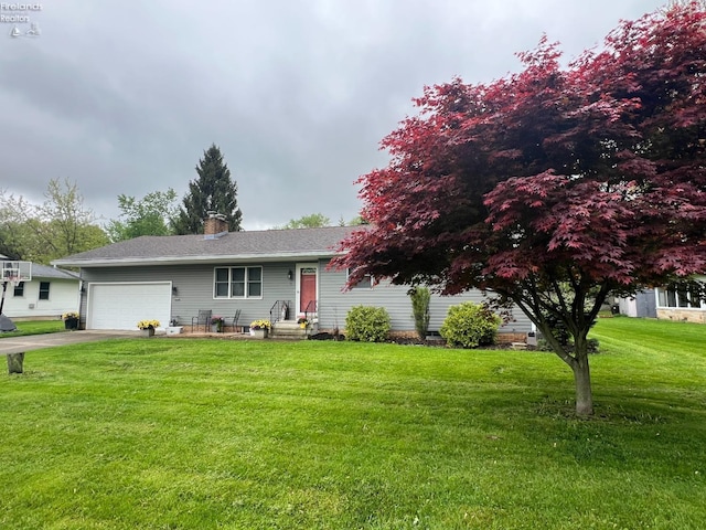 view of front of property featuring driveway, an attached garage, a chimney, and a front yard