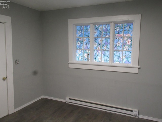 604 E Jefferson St, Sandusky, OH 44870 - unfurnished room featuring baseboard heating, dark wood finished floors, and baseboards
