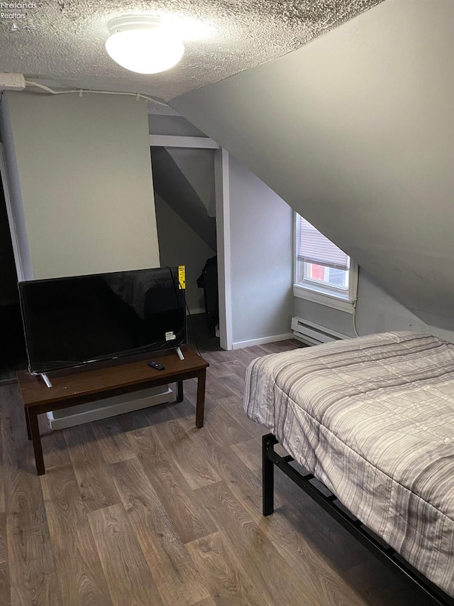 604 E Jefferson St, Sandusky, OH 44870 - bedroom with a baseboard heating unit, wood finished floors, lofted ceiling, and a textured ceiling