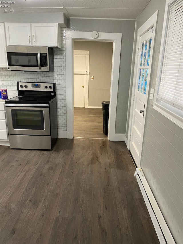 604 E Jefferson St, Sandusky, OH 44870 - kitchen with stainless steel appliances, baseboard heating, white cabinets, dark wood-style flooring, and backsplash