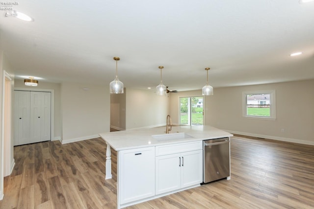 412 E 10th St, Port Clinton, OH 43452 - kitchen with a sink, dishwasher, open floor plan, light countertops, and a kitchen island with sink