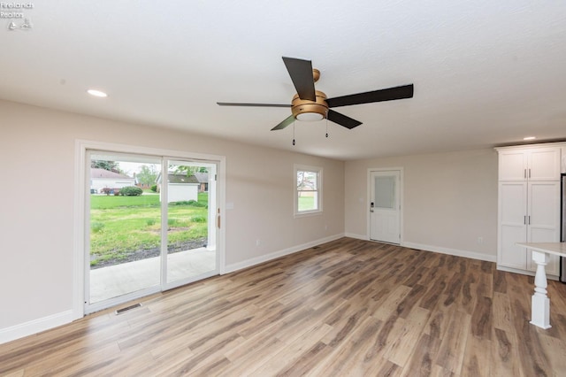 412 E 10th St, Port Clinton, OH 43452 - unfurnished living room featuring light wood-style flooring, baseboards, ceiling fan, and recessed lighting