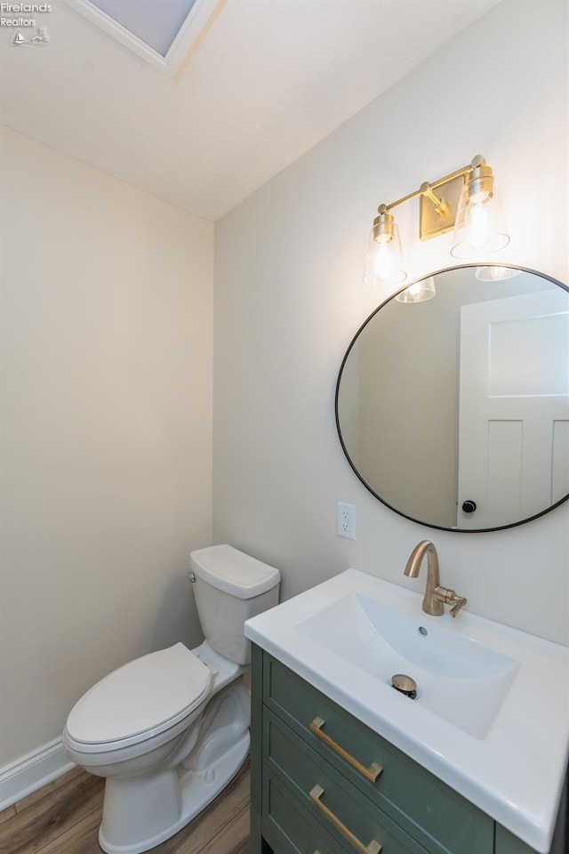 412 E 10th St, Port Clinton, OH 43452 - bathroom with toilet, wood finished floors, and vanity