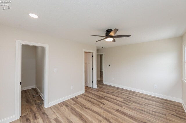 412 E 10th St, Port Clinton, OH 43452 - empty room with a ceiling fan, light wood-style floors, and baseboards