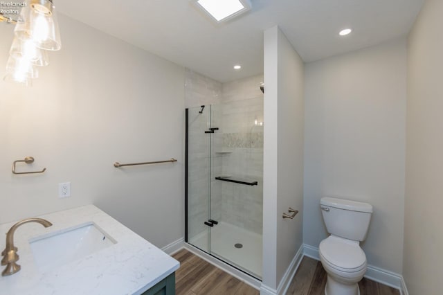 412 E 10th St, Port Clinton, OH 43452 - bathroom with wood finished floors, a shower stall, toilet, baseboards, and recessed lighting