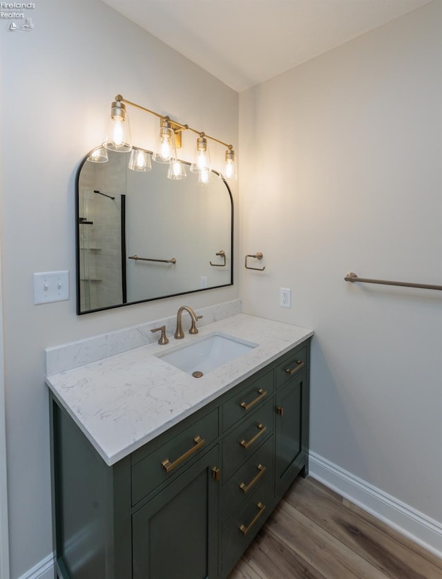412 E 10th St, Port Clinton, OH 43452 - bathroom featuring wood finished floors, baseboards, and vanity