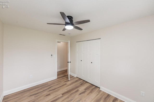 412 E 10th St, Port Clinton, OH 43452 - unfurnished bedroom with baseboards, light wood finished floors, a closet, and ceiling fan