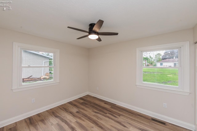412 E 10th St, Port Clinton, OH 43452 - spare room featuring healthy amount of natural light, wood finished floors, and baseboards