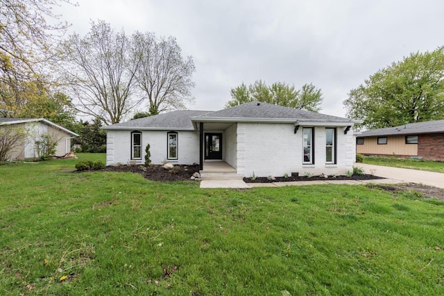 412 E 10th St, Port Clinton, OH 43452 - view of front of house featuring a front yard, brick siding, and a shingled roof