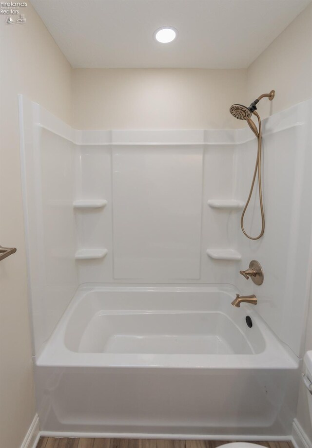 412 E 10th St, Port Clinton, OH 43452 - full bathroom featuring wood finished floors and bathing tub / shower combination