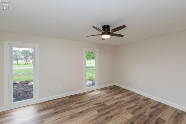412 E 10th St, Port Clinton, OH 43452 - empty room with plenty of natural light, wood finished floors, a ceiling fan, and baseboards