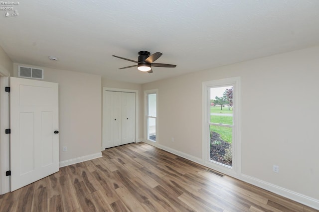 412 E 10th St, Port Clinton, OH 43452 - unfurnished bedroom with wood finished floors, baseboards, and ceiling fan