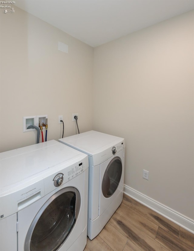 412 E 10th St, Port Clinton, OH 43452 - clothes washing area with separate washer and dryer, light wood-style floors, and baseboards