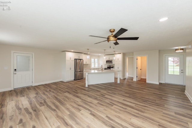 412 E 10th St, Port Clinton, OH 43452 - unfurnished living room featuring recessed lighting, baseboards, light wood-type flooring, and a ceiling fan